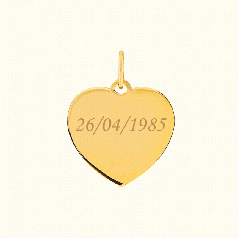 Heart-shaped pendant in plated gold featuring engraved date 26/04/1985 for personal or sentimental jewelry.