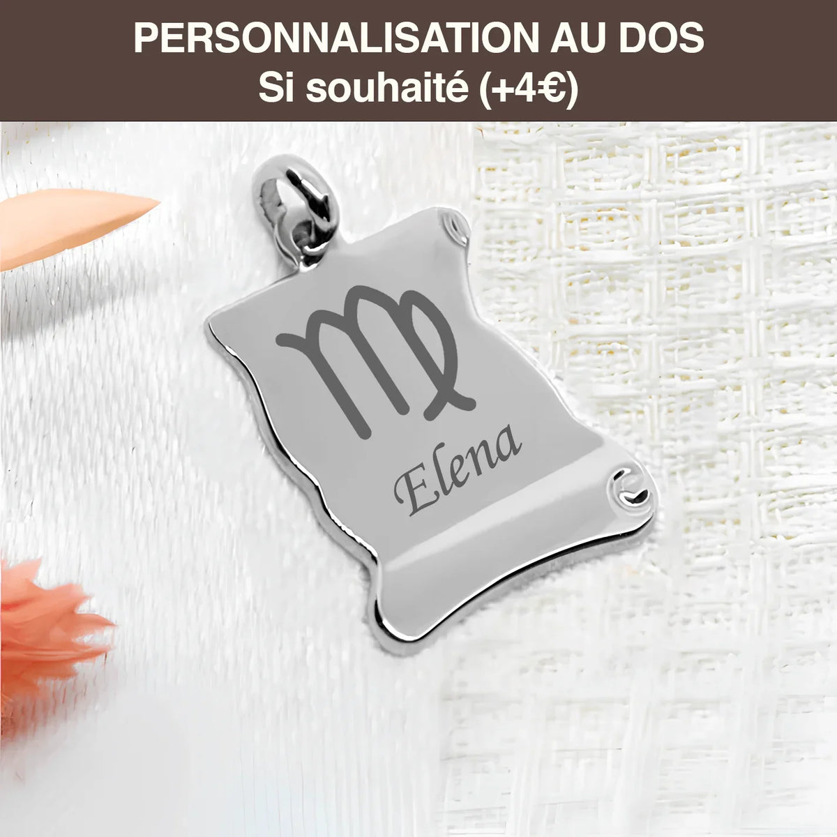 Personalized gold EngravingPhoto heart pendant in the shape of a parchment with engraving astrological sign and first name Elena, placed on white fabric.