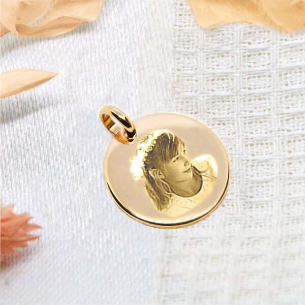 Personalized gold heart pendant Photo Engraving with engraved photo, white fabric background.