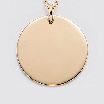 Large round medallion in golden steel engraved with a text