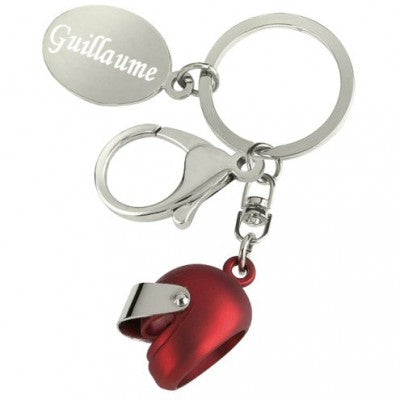 Red motorcycle helmet key ring with engraved text.