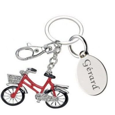 Engraving of a text on a red bicycle key ring