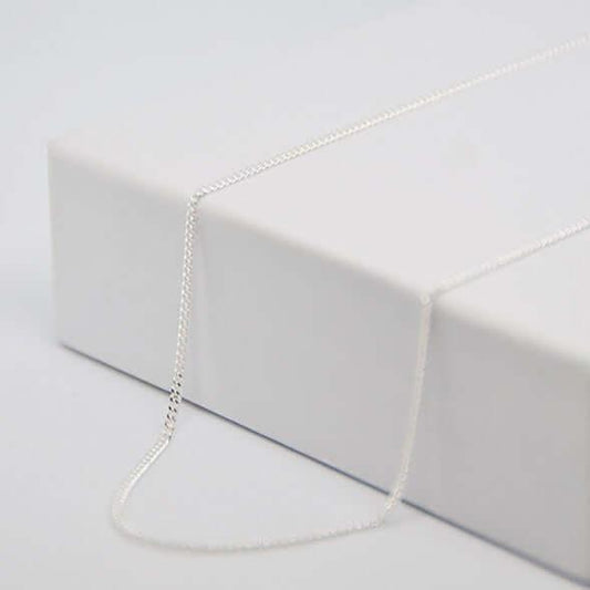 Chaîne fine en argent GravurePhoto, présentée sur une boîte blanche, prête pour pendentif personnalisé.